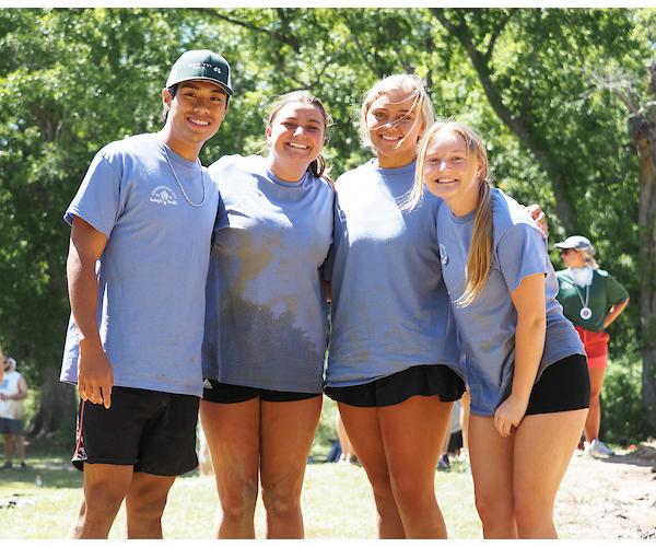 4 students smiling in group picture during oozeball.
