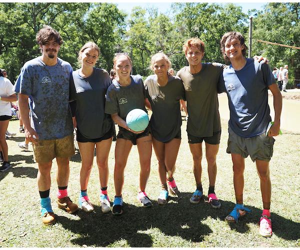 Group image of team at oozeball holding the ball.